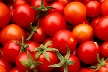 Juicy little red and orange cherry tomatoes close up