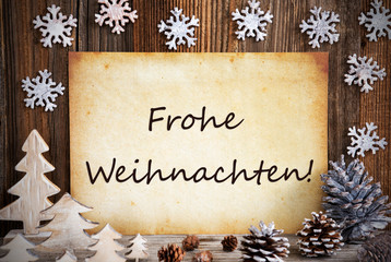 Fototapeta na wymiar Old Paper With German Text Frohe Weihnachten Means Merry Christmas. Christmas Decoration Like Tree, Fir Cone And Snowflakes. Brown Wooden Background