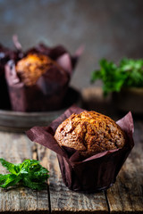 Homemade fresh baked carrot muffins with hazelnut and orange on wooden background