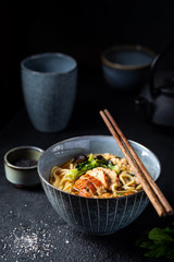 japanese soup with fried eel Yanagawa Nabe in a bowl on dark background