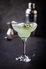 margarita cocktail with lime in a glass on dark background