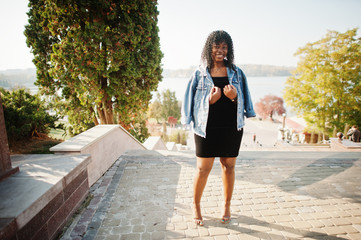 Stylish trendy afro france curly woman posed at autumn day in jeans jacket. Black african female...