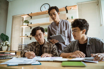 portrait of asian creative team working together in the contemporary design office