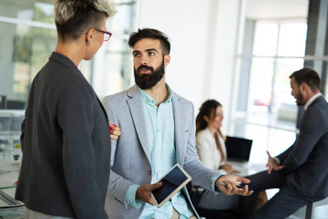 Image of business partners discussing documents and ideas at meeting