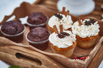 muffins with cinnamon on a wooden tray close-up. horizontal image