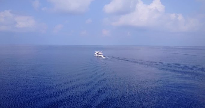 Beautiful Tourist Luxury Yacht in the Vast Depth Blue Ocean With White Sky Above in Greece - Wide Shot