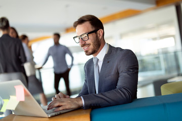 Portrait of young man sitting at desk in the office