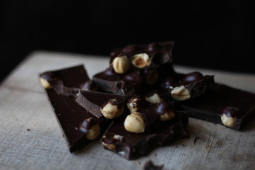 broken pieces of black chocolate with nuts