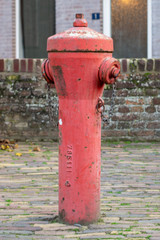 Fototapeta na wymiar A Typical Vintage Dutch red Hydrant