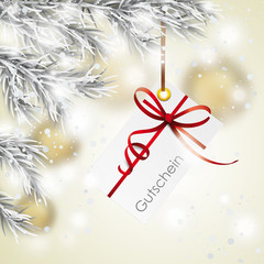 Fototapeta na wymiar Weihnachtsgutschein unter dem verschneiten Weihnachtsbaum mit goldenen Weihnachtsbaum