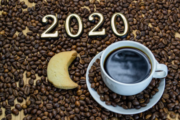 a cup of coffee with cookies, coffee grains scattered on a table near a cup with a coffee