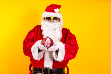 Santa Claus holding Christmas ball