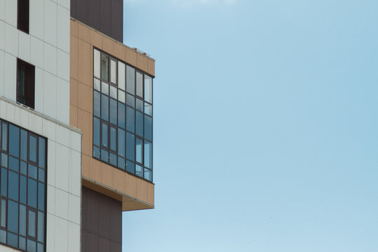 Part of modern residential apartment house building. Including a place for copy space. Blue sky with clouds