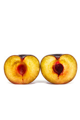 A plum cut into 2 parts on white background