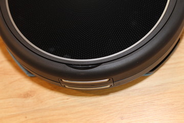 Robot Vacuum Cleaner cleaning the floor around a wooden. Modern