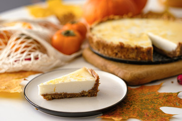 Obraz na płótnie Canvas pumpkin cheesecake with persimmon. autumn concept.