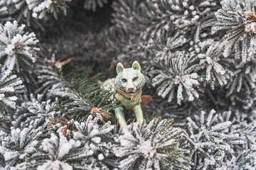 Christmas toy in the shape of a wolf on a Christmas tree close up