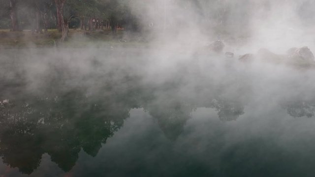 Morning haze over water surface in natural hot spring