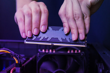 Installation of modern DDR memory module with heat sink. High performance memory for gaming....