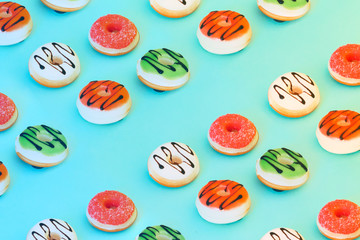 Sweet colorful pattern of donuts on blue background.