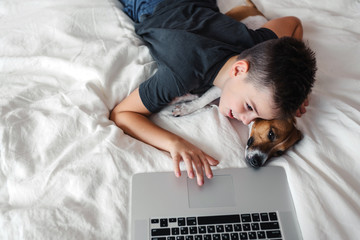 A young boy with a dog in a cozy interior.