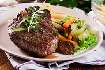 Beef steak served with baked potatoes