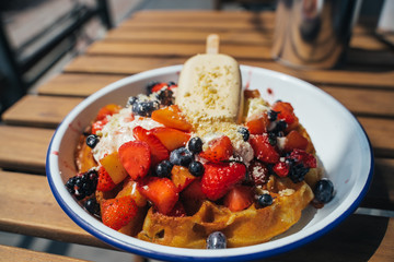 Delicious waffles with berry and ice cream