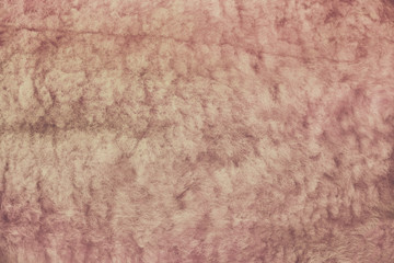 Brown wool rug texture. Background, wool, skins beige. Sheepskin fur texture, close-up.