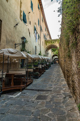narrow street with restaurant in italy