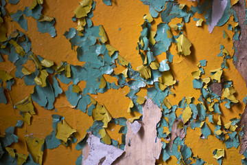 abstract background of yellow and light blue paint peeling from wall