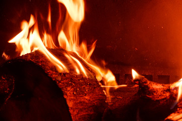 Burning logs in an indoor fireplace