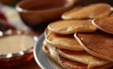 Breakfast with a cup of tea, sour cream and homemade pancakes