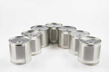 Group of silver canned food on white background.