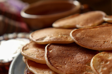 Breakfast with a cup of tea, sour cream and homemade pancakes