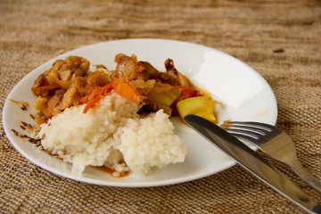 rice and vegetable stew with chicken meat on a white plate. Home cooked food. Asian recipes