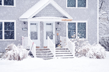 a small cozy house covered with snow during the snowfall. The atmosphere of winter comfort and...