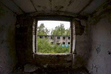 Fototapeta na wymiar Abandoned East Germany soviet military base Window facing abandoned building