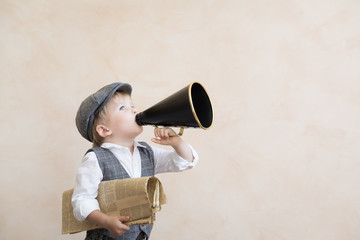 Child shouting through vintage megaphone
