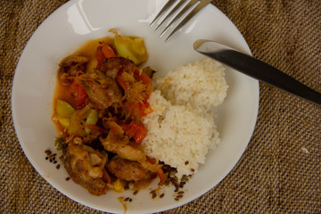 rice and vegetable stew with chicken meat on a white plate. Home cooked food. Asian recipes