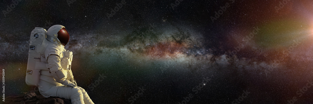 Canvas Prints astronaut sitting on a cliff enjoying the view over an exoplanet