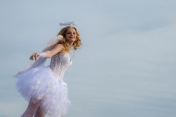 Real fairy from magical stories. Concept of innocent child. A beautiful teen with blonde curly hair...