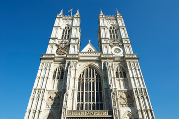 Fototapeta na wymiar Bright sunny afternoon view of the gothic Western facade of Westminster Abbey, in London, UK