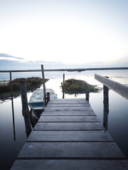Fototapeta premium Wooden pier on the lagoon, during sunset.