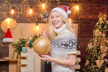 Snow Maiden beautiful girl hold a decorate ball at christmas background. Happy smiling blonde girl...
