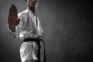 Gordijnen Karate martial arts fighter on dark background © fotokitas
