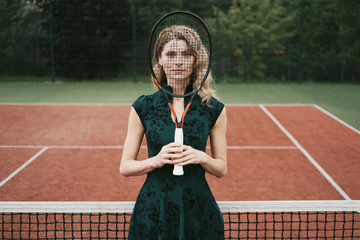 Luxury glamour fashion woman on tennis court holding racket and posing like model