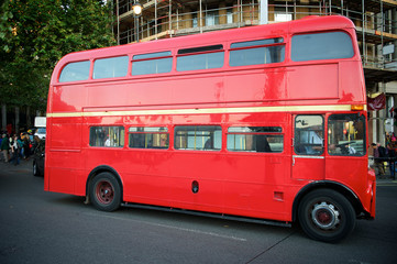 Fototapeta na wymiar Classic red double-decker Routemaster bus passing on a London, UK street
