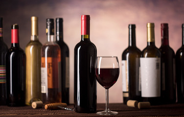 Red Wine in glass and bottles on a dark background with copy space