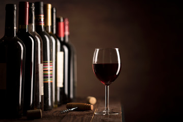 Red Wine in glass and bottles on a dark background with copy space