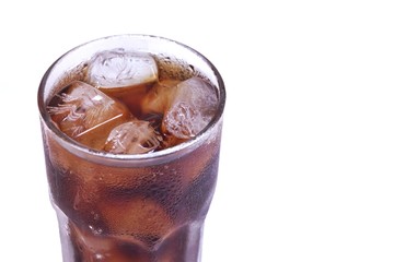 A cola glass with ice on white isolated background and copy space 